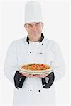 Portrait of happy male chef with pizza over white background