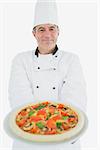 Portrait of happy chef offering pizza over white background