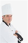 Portrait of confident chef with arms crossed standing against white background