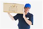 Portrait of happy delivery man carrying package against white backgeound