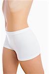 Female slender body in shorts over white background