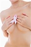 Naked woman holding breast cancer ribbon over breasts aganist white background