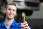 Portrait of male mechanic gesturing thumbs up