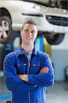 Portrait of confident male mechanic with arms crossed