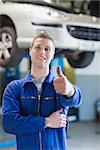 Portrait of happy male mechanic gesturing thumbs up