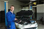 Portrait of male repairman using laptop in workshop