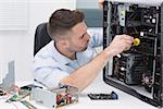 Hardware professional examining cpu with stethoscope at workplace