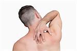 Rear view of shirtless man with neck pain over white background