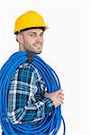 Portrait of smiling young male architect carrying coiled blue tubing over white background