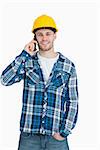 Portrait of young male architect using cellphone over white background