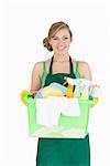 Portrait of young maid carrying cleaning supplies over white background