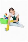 Young maid cleaning floor over white background