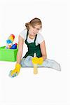 Portrait of young maid cleaning floor over white background