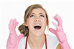 Closeup of young maid in pink gloves screaming over white background