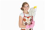 Portrait of smiling young woman with cleaning supplies over white background