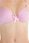 Closeup of woman in bra with breast cancer awareness ribbon