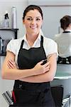 Portrait of confident female hairdresser with hair scissors