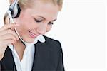Closeup of young business woman wearing headset over white background