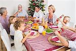 Family having christmas dinner together at table in kitchen