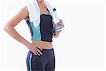 Sporty woman with towel around neck and water bottle over white background