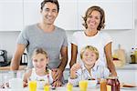 Happy family at breakfast in kitchen
