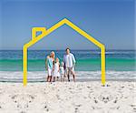 Family posing with a yellow house illustration on a beach
