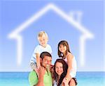 Smiling family posing with a blurred house illustration and the sea behind them