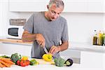 Man cutting pepper in the kitchen