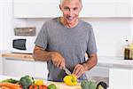 Man cutting a yellow pepper in the kitchen