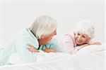 Elderly couple chatting in bed