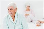 Elderly couple not talking to each other in bedroom