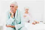 Elderly couple not speaking in bedroom