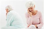 Elderly couple not talking to each other in bedroom