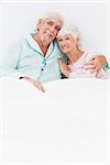 Happy old couple sitting in bed