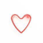 Pink heart shaped cookie cutter on white background