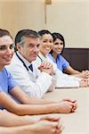 Cheerful medical team sitting in conference room