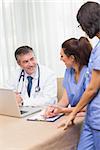 Happy nurses chatting with doctor in a meeting