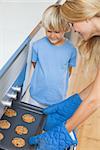 Mother and her son baking cookies in the kitchen