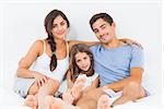 Cheerful family sitting on the bed