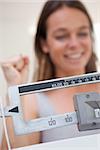 Scale showing dieting success to cheerful woman