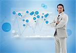 Businessman standing against a digital world map and graphs