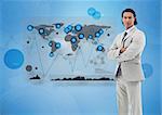 Serious businessman standing with a digital world map and graphs