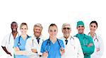 Smiling medical team standing arms crossed in line on white background
