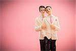 Gay groom cake toppers on pink background