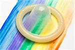 Condom on gay pride rainbow brush stroke