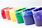 Rainbow paint pots in a line for gay pride on white background