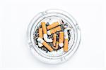 Overhead of full ashtray on white background