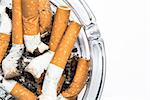 Close up overhead of ashtray on white background with copy space