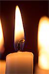 Close up of lit candle on dark background