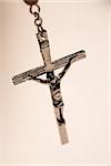 Close up of crucifix of rosary beads on white background